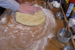 Degassing the dough.
